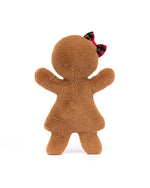 Back view of a brown plush toy with outstretched arms, no visible facial features, and a small red and black plaid bow on top of its head.