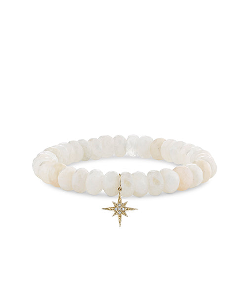 14k gold and pavé diamond starburst charm on 8mm natural African rainbow moonstone bead on white background.