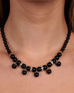 Close up on models neck wearing Marquise Eye & Onyx Beaded Necklace.