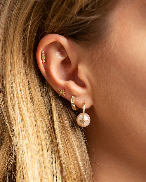  Starburst Pearl Earrings on a model stacked with three other to show  overall look.