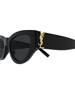 Close-up of the temples of black sunglasses with a gold monogram logo on each side.