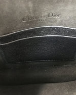 The inside of a a Christina Dior bag showing two card pockets and "Christian Dior Paris" embossed on the leather.