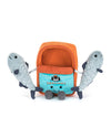 Plush toy shaped like a sardine can with orange and blue colors, featuring the word 'SARDINAS', an illustration of two sardines and a cat, two attached gray sardine plushies with dark blue fins, and a smiling face with eyes and mouth at the bottom.
