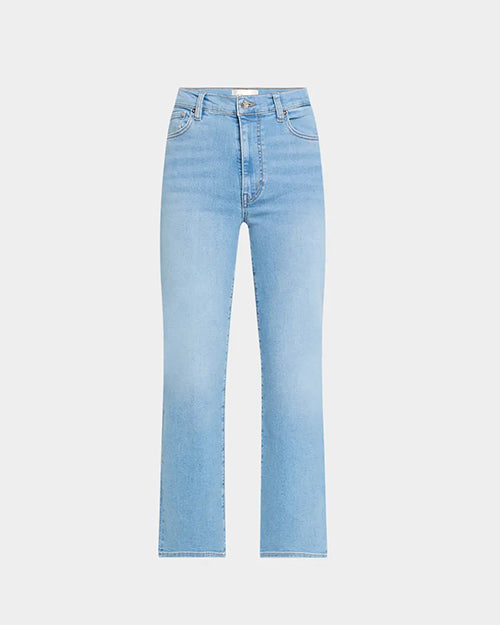 A person wearing light blue high-waisted jeans with zipper closure and belt loops, as well as two front pockets with a coin pouch. 