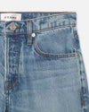 Close-up of a medium wash denim jeans with a Straight-cut design with stitched hem.