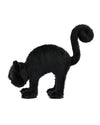 Black plush cat with fluffy fur, arched back, and curled tail, appearing in a startled or defensive posture with forward-facing eyes.