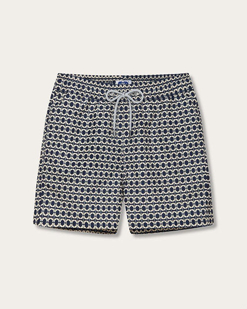A pair of swim shorts with a distinctive pattern. The shorts feature small, interconnected circles in shades of blue and white. They have a white and grey drawstring at the waist for adjustment.