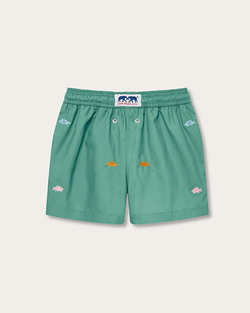 A back view of a pair of green children’s shorts with an elastic waistband and a white drawstring. The shorts feature embroidered multicolored sea flowers in various poses scattered across the fabric.