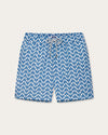 A pair of blue and white patterned swim shorts with a grey drawstring at the waist. The pattern consists of zigzag lines. 