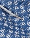 A close-up view of a blue fabric with a repeating pattern of white Moorish Idol fish. The close-up showcases a part of the white and grey drawstring.