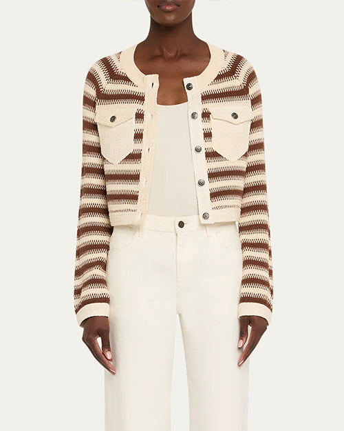 Person wearing a striped cardigan over a white outfit on a plain background