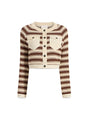 Striped cardigan in brown and ivory with button details on a white background