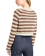 Back view of a person wearing a brown and beige striped sweater with blue jeans on a white background
