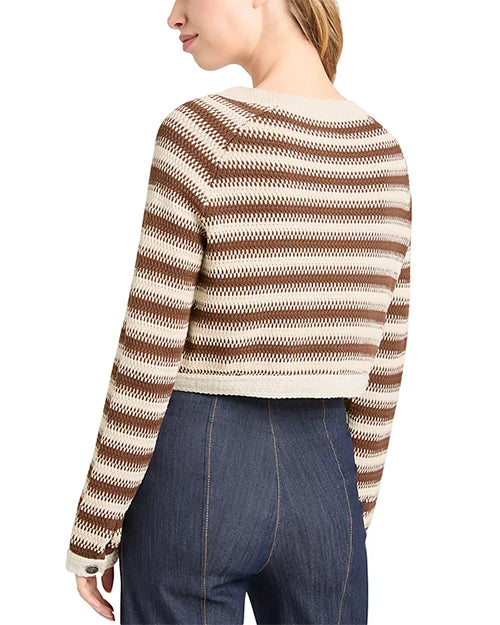 Back view of a person wearing a brown and beige striped sweater with blue jeans on a white background