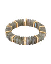 Circular bracelet made of rectangular greyish-green stones, accented with gold-colored spacers embedded with small, clear gemstones.