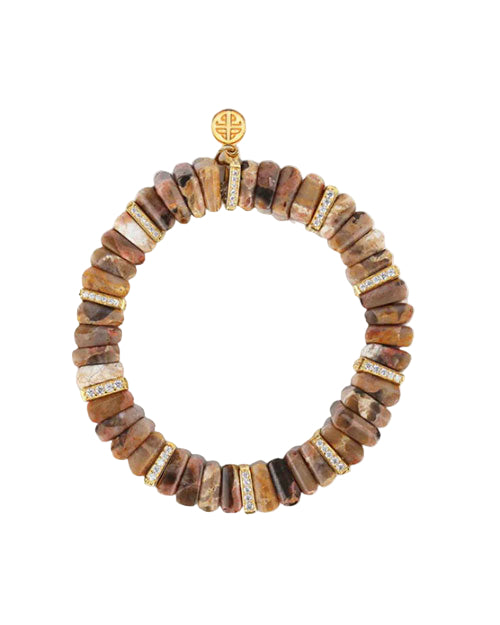Circular bracelet made of brown, irregularly shaped beads, accented with gold-colored spacers embedded with clear stones. A round gold charm with an intricate design is positioned at the top.