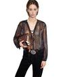 Person wearing a sheer long-sleeved blouse with a lace-up neckline, black pants with a decorative belt buckle, and holding a small maroon handbag with a keychain.