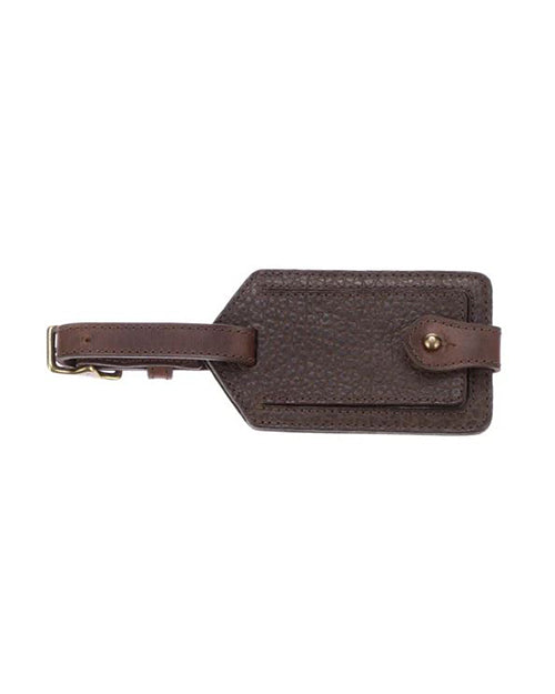 A detailed luggage tag made of textured dark brown leather with a buckle strap .
