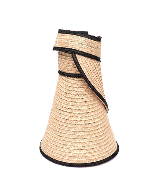 A beige woven hat with black trim rolled into a conical shape, with the brim wrapped around itself for compact packing.