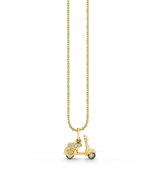 A gold necklace with a pendant in the shape of a classic scooter on a plain white background. The scooter pendant is detailed, featuring wheels, a seat, and handlebars. The chain is thin and delicate, suggesting the jewelry piece is elegant and possibly intended for fashion purposes.