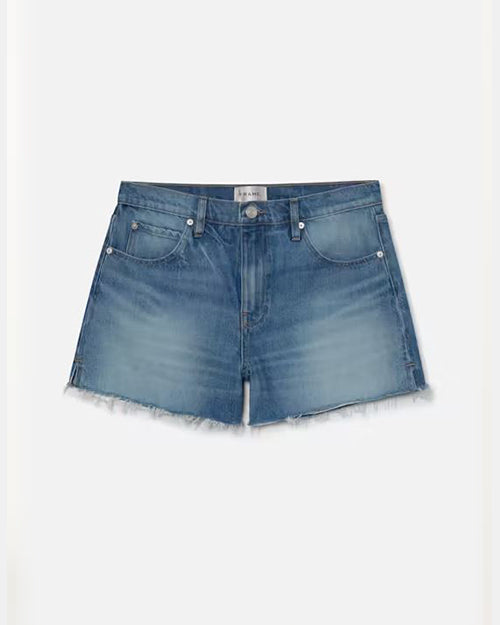A pair of denim shorts with frayed hems and a slightly faded pattern, with a white rectangular tag in the inner waistline. The background is white.