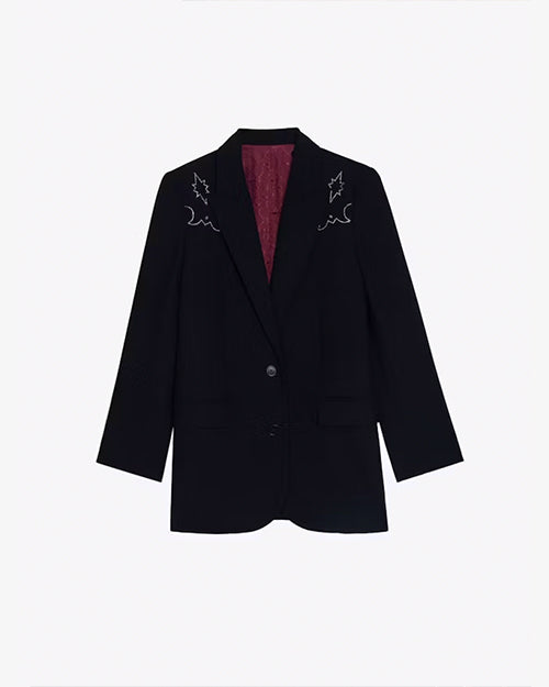 A full view of a black blazer with white embroidery on the shoulders, and a maroon-colored inside. The background is plain white.