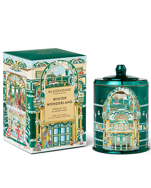 Green candle and packaging with festive design on a white background