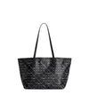 A black tote bag with two long handles, featuring a pattern of small white dots arranged in a diamond grid, each diamond containing a crescent shape.