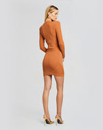 A back view of an orange long sleeve dress, with gold buttons aligned in a double-breasted fashion. The dress has ribbed, metallic material. 