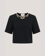 A black short-sleeved top with an embellished jeweled neckline.