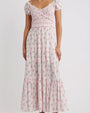 Light pink floral maxi dress with short puff sleeves, smocked bodice, wrap-style V-neckline, and tiered ruffle skirt.