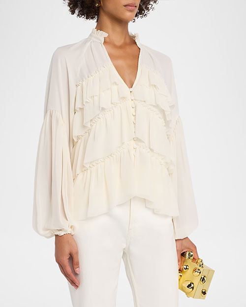 
Cream ruffle-front blouse with a split neckline, button detail, and voluminous long sleeves, paired with white pants.