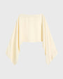 Cream-colored cropped top with a wide neckline and long, draped sleeves, shown against a light background.