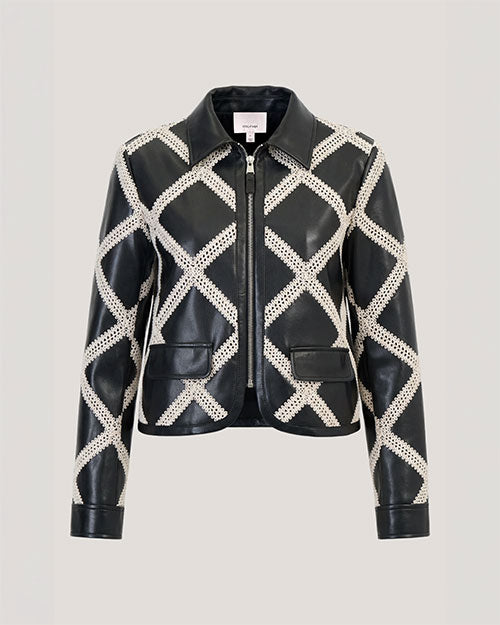 A cropped black leather jacket with an ivory diamond-pattern overlay and front zip closure