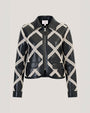 A cropped black leather jacket with an ivory diamond-pattern overlay and front zip closure