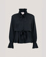 A black ruffle-neck peplum top with a tie-front detail and voluminous sleeves