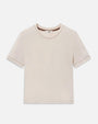 A beige baby tee with brown contrast stitching. 