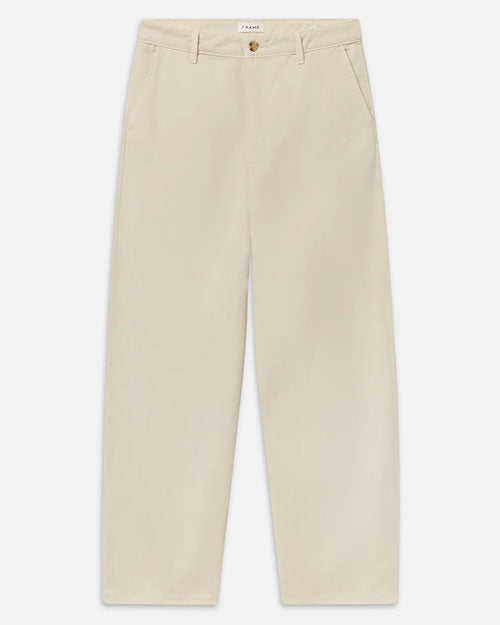 Product image of cream-colored wide-leg trousers with a relaxed fit, flat front, belt loops, slanted side pockets, and a button-and-zip closure. The full-length trousers are shown laid flat against a light gray background.