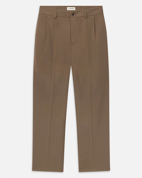 Product image of taupe tailored trousers with a straight-leg silhouette, pressed front creases, belt loops, side slit pockets, and a button-and-zip closure. The full-length trousers are shown laid flat against a light gray background.