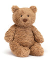 A plush teddy bear with light brown, fluffy fur, sitting upright. The bear has round black eyes, a triangular brown nose, and soft, rounded ears. Its limbs are slightly floppy, giving it a cuddly appearance.