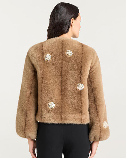 Back view of a light brown faux fur jacket featuring a round neckline, long sleeves, and decorative pearl-like embellishments arranged in circular patterns across the back and sleeves.