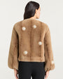 Back view of a light brown faux fur jacket featuring a round neckline, long sleeves, and decorative pearl-like embellishments arranged in circular patterns across the back and sleeves.