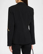 Back view of a fitted black tailored blazer with a single gold embroidered leaf detail on the sleeve and a structured silhouette.