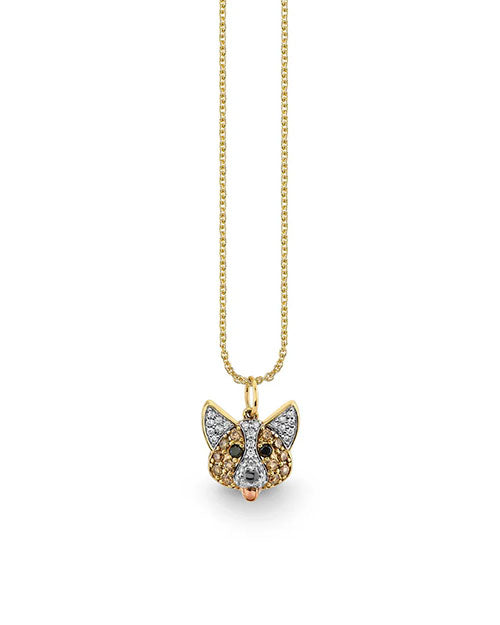 Gold necklace featuring a pendant shaped like a corgi's head, adorned with white, brown, and black pavé-set gemstones for a detailed, sparkling design. The pendant hangs from a delicate gold chain.