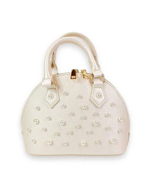 Small ivory dome-shaped handbag with dual top handles, gold-tone hardware, and decorative pearl studs arranged across the front.
