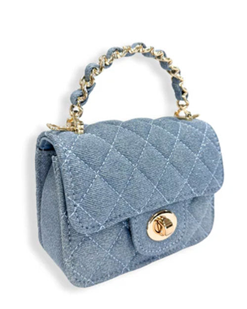 Small light blue denim handbag with a quilted diamond pattern, gold-tone twist-lock closure, and a short handle featuring interwoven blue material and gold chain links, shown at an angled view.