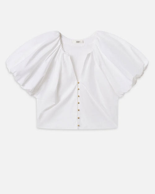 White short-sleeve blouse with oversized puff sleeves and a deep V-neckline, featuring a row of small gold buttons down the front. The fabric appears smooth and structured.