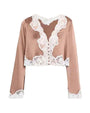Blush satin cropped blouse with white scalloped lace trim, featuring a deep V-neckline, front button closure, long sleeves, and a cropped hem.