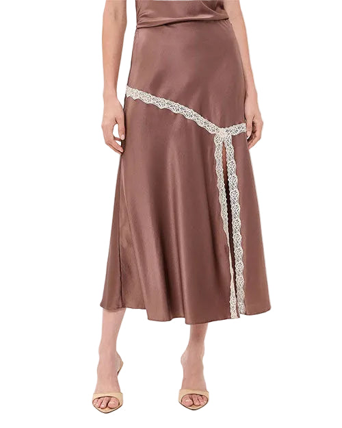 Close-up of a mauve satin midi skirt with contrast ivory lace trim in an asymmetrical diagonal panel, creating a flowing, slip-inspired silhouette.