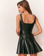 Back view of a black leather mini dress featuring a square neckline, wide shoulder straps, and a fitted bodice with vertical seam detailing. The dress has a flared skirt that creates a structured, A-line silhouette.